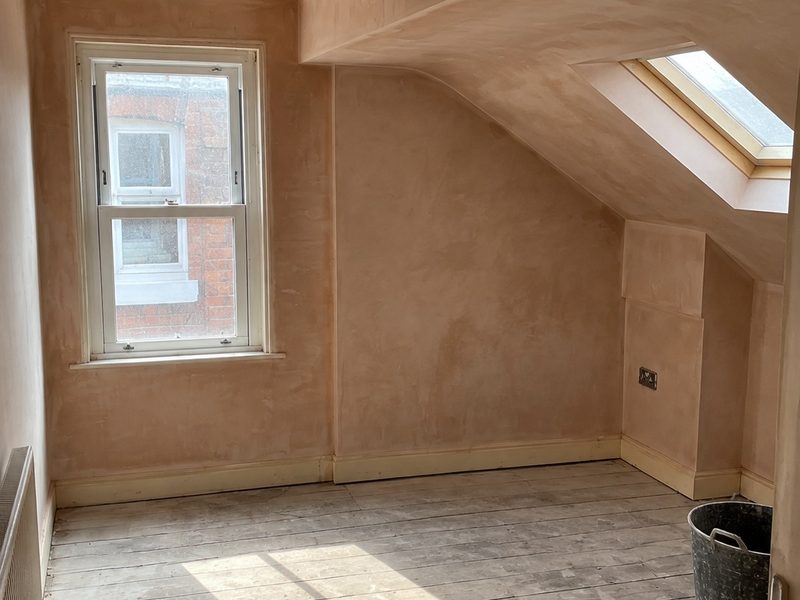 A room stripped back to bare brick before plastering