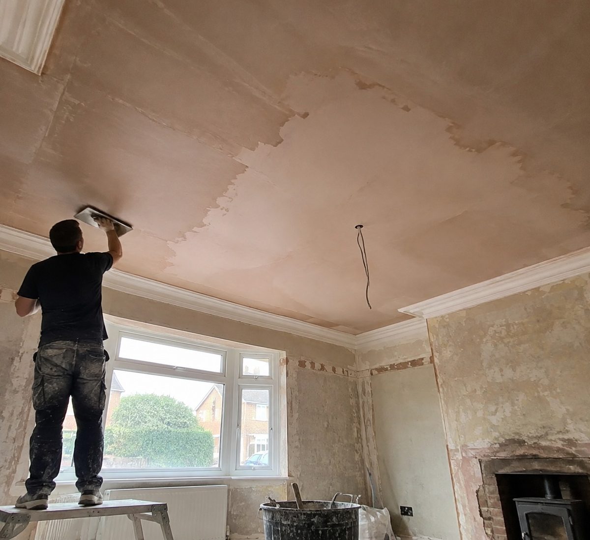 A village cottage ceiling being replastered