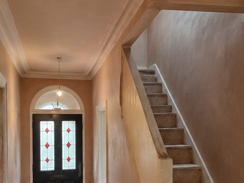 A finished skimmed wall with daylight raking across it