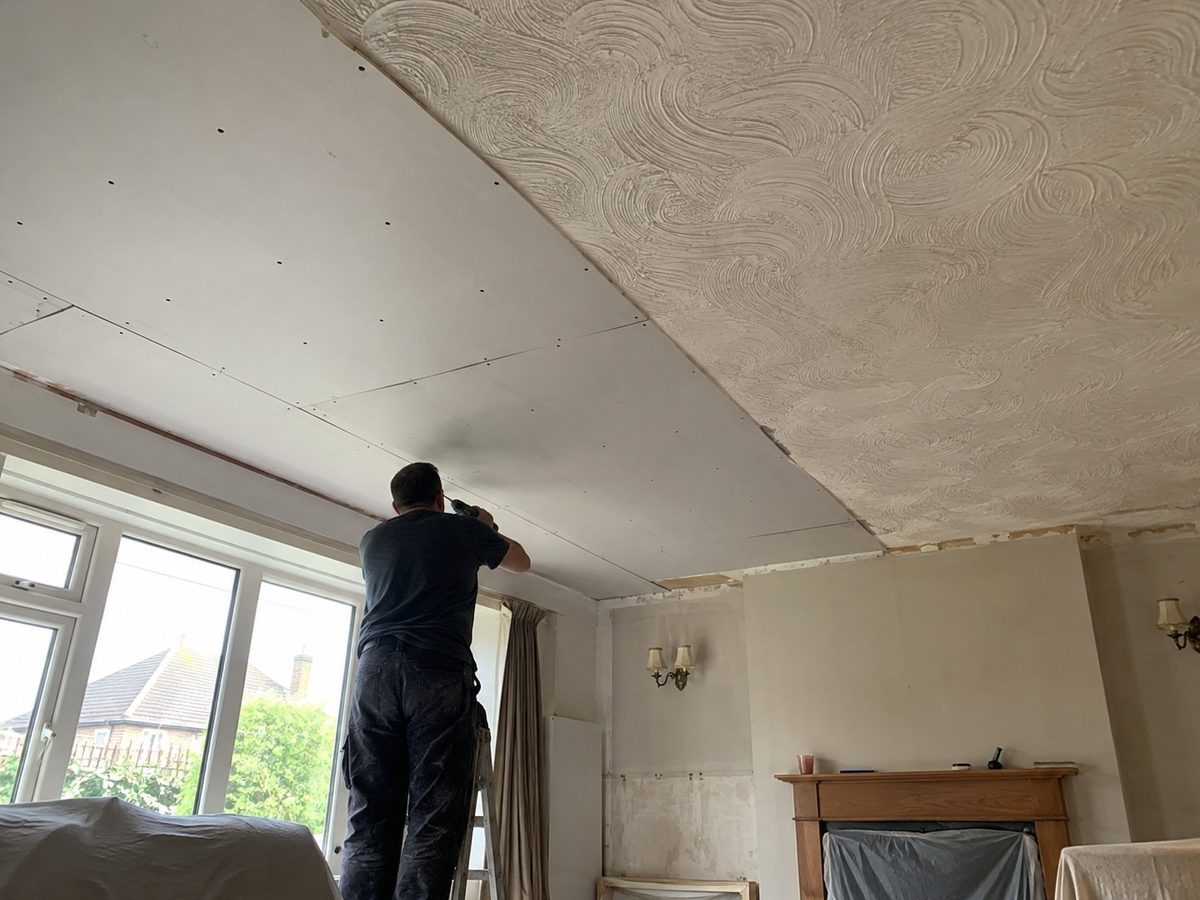 An artex ceiling part covered, the pattern still showing on one side