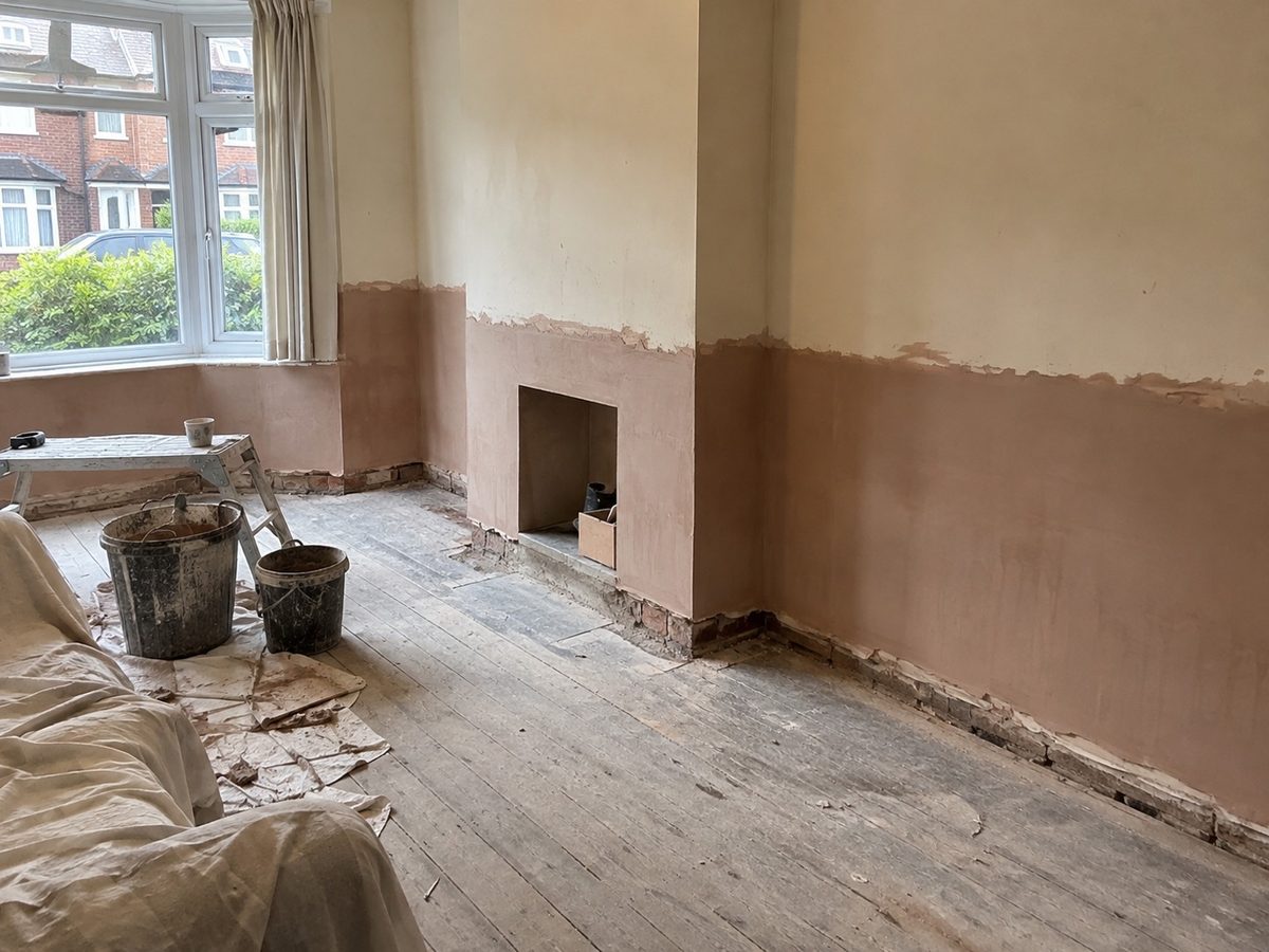 The bottom metre of a hall wall stripped back after damp treatment