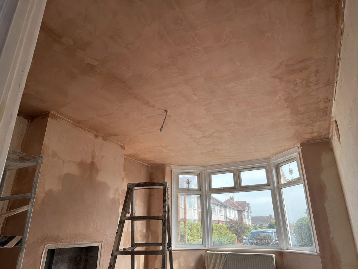 Lath and plaster seen from above between the joists