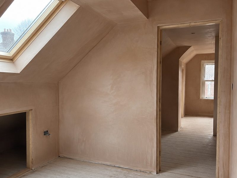 A finished skim, even and pale, before any paint
