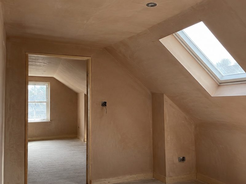 A finished plastered wall with daylight raking across it
