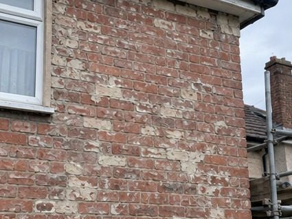 Pebbledash stripped back to the brick beneath