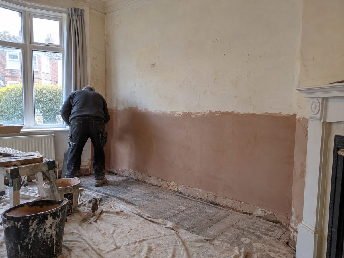 A wall replastered on a render coat and finished